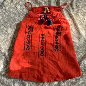 Red sleeveless top with blue embroidery